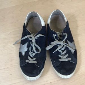 Golden Goose: extremely worn navy blue Superstars.